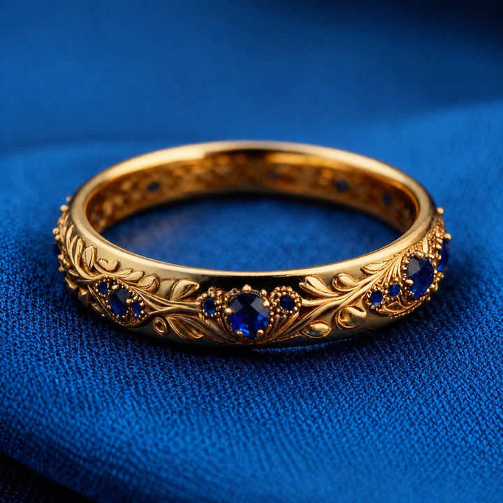 Gold Eternity Ring with Blue Sapphire and Floral Motif